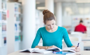 pretty young college student in a library (shallow DOF; color toned image)